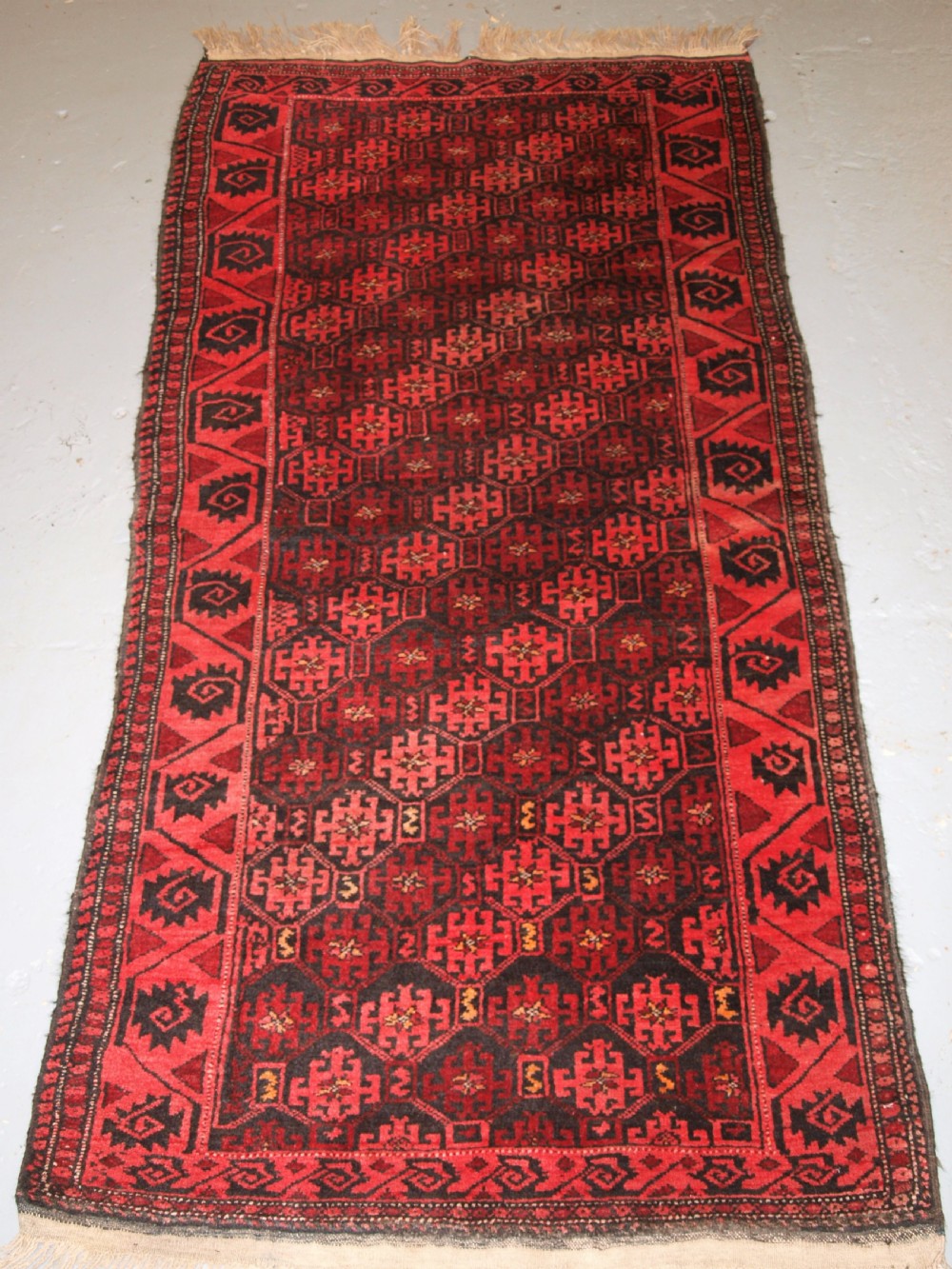 old afghan rug with repeat design curl leaf border rustic charm circa 1920