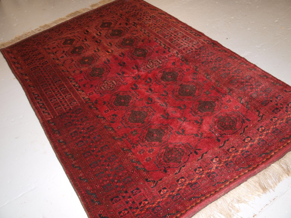 old afghan village rug with turkmen chuval gul design plum red colour circa 1920
