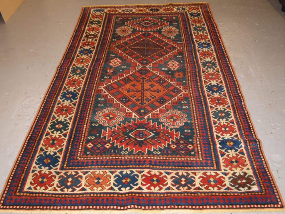 antique caucasian karachop kazak with green ground circa 1880
